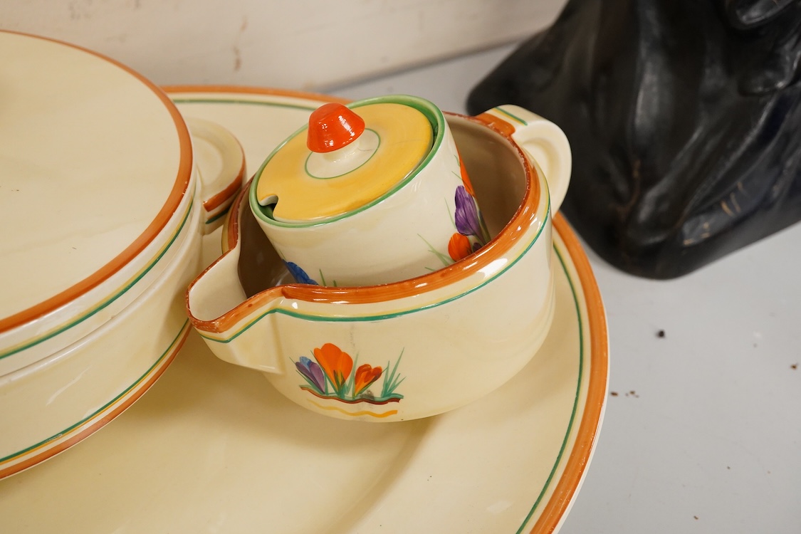 A Clarice Cliff ‘crocus pattern’ tureen and cover, jug, honey pot with cover and an oval meat platter - 43cm wide